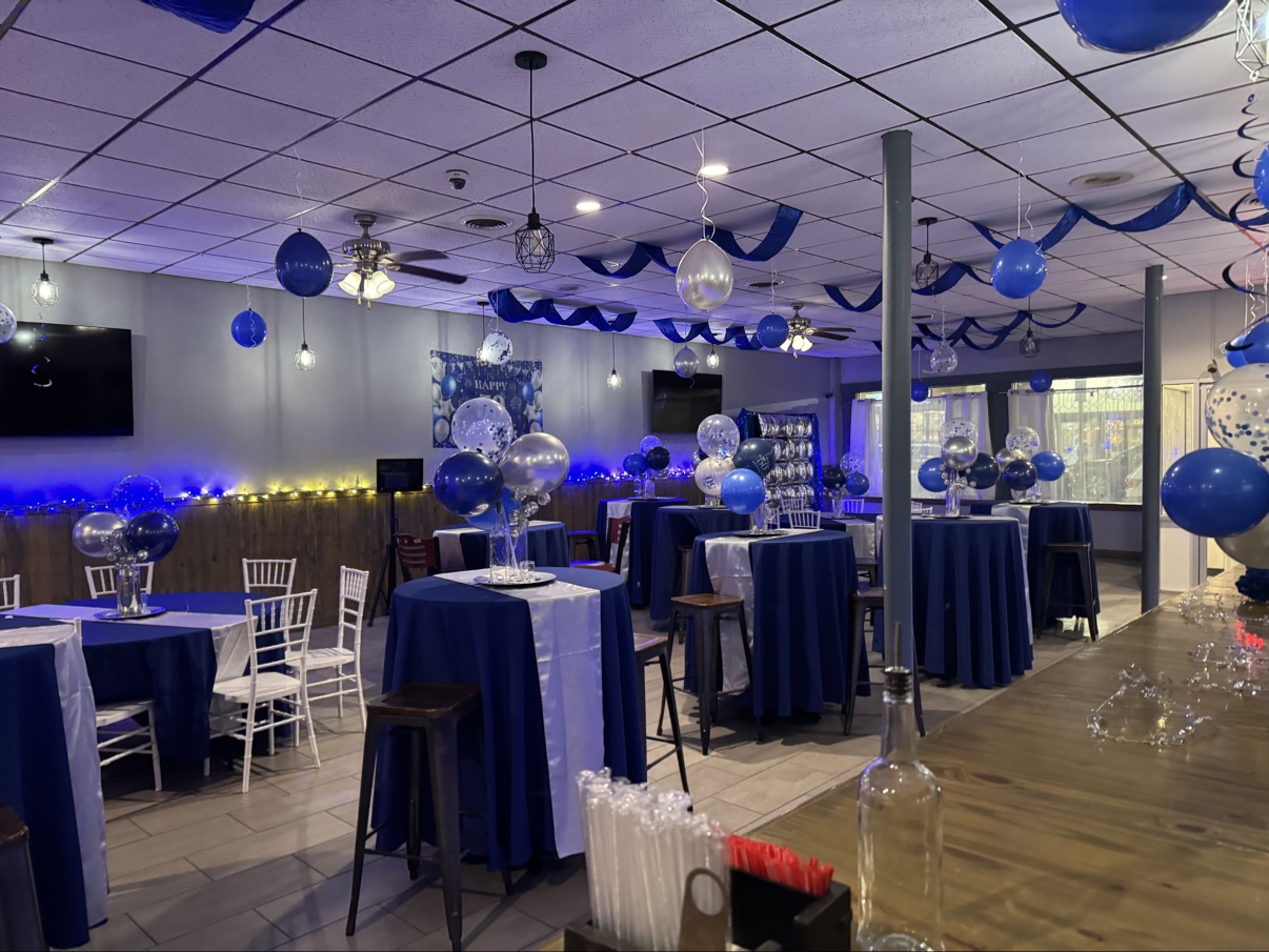 Cuatro Amigos event hall decorated with blue and silver balloons for a party